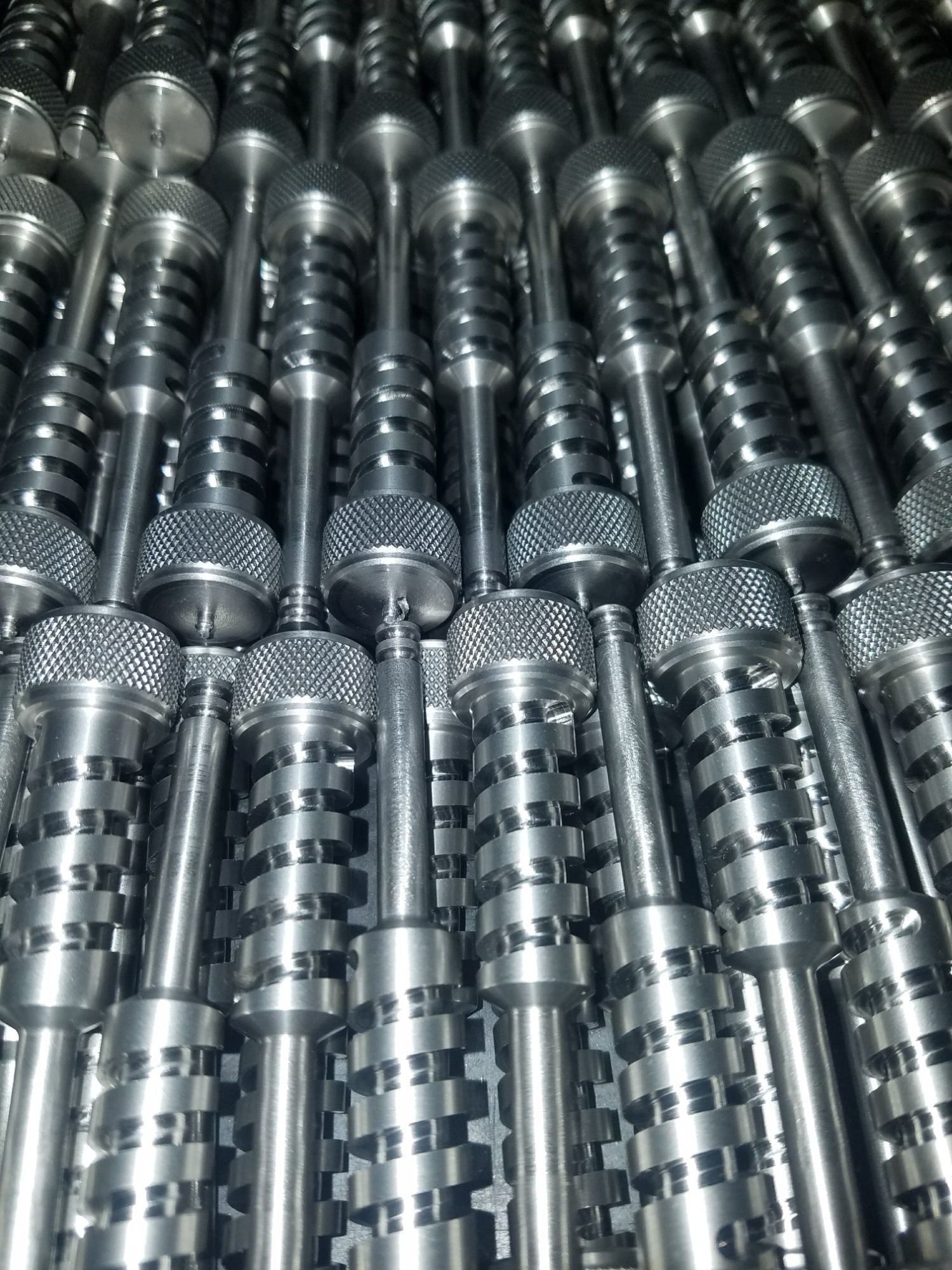 Production run of precision turned stainless steel components with knurling
